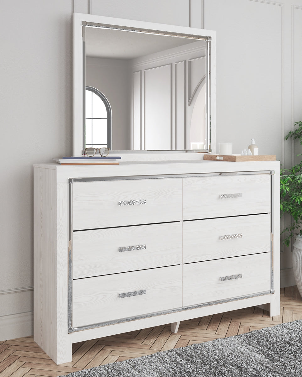 Cama Altyra tapizada con almacenaje, cómoda con espejo y mesita de noche