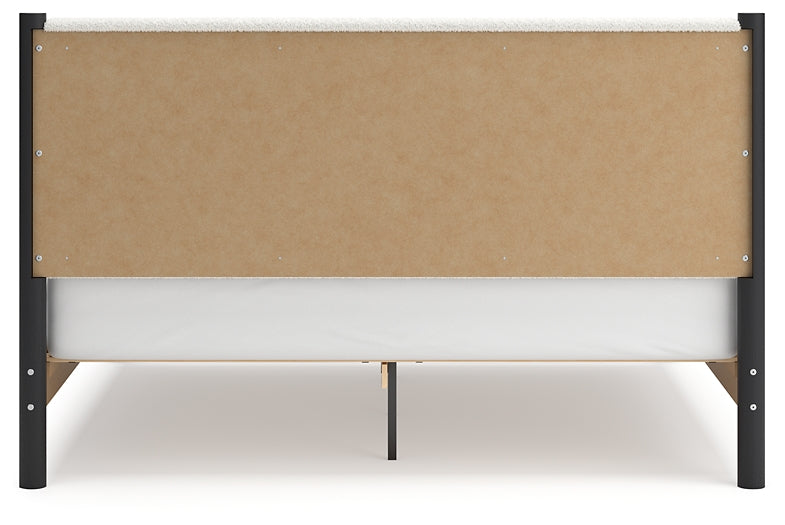 Cama Cadmori tapizada con paneles y cómoda con espejo