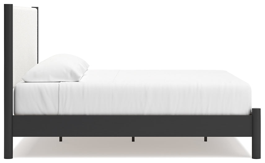Cama Cadmori tapizada con paneles y cómoda con espejo