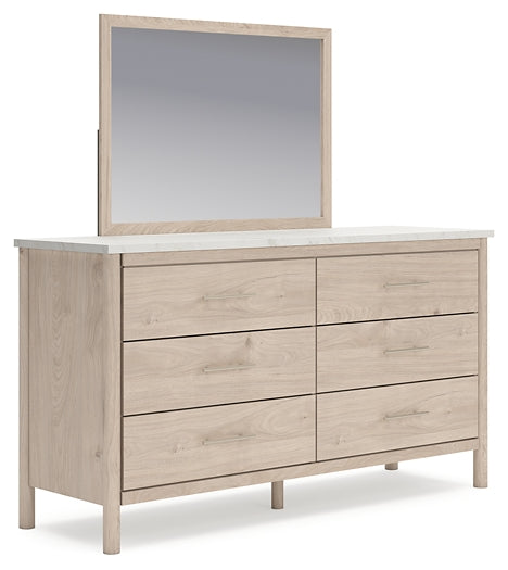 Cama Cadmori tapizada con paneles y cómoda con espejo