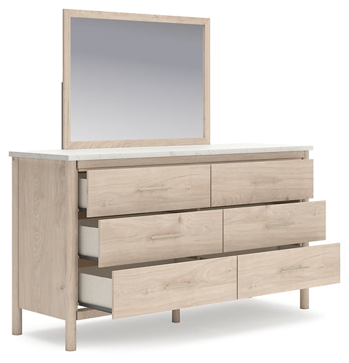 Cama Cadmori tapizada con paneles, cómoda y espejo