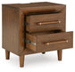 Lyncott  Upholstered Panel Bed, Dresser, Mirror, Chest And Nightstand